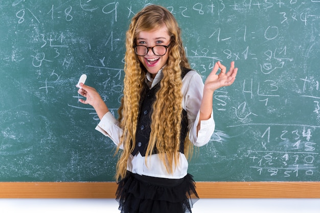 Nerd pupil blond girl in green board schoolgirl Premium Photo
