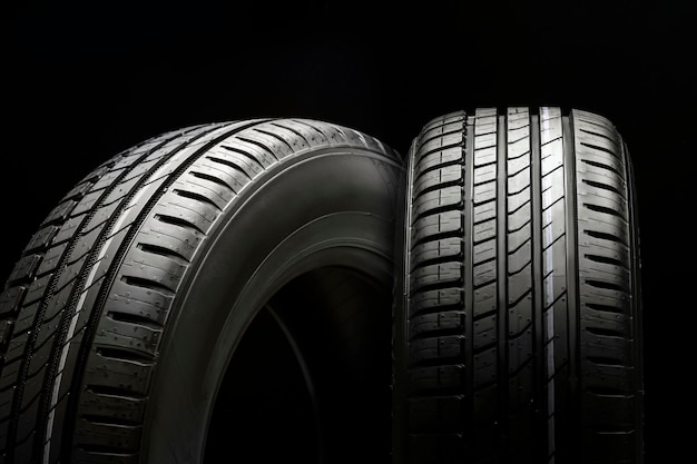 Premium Photo | New beautiful tires on a black background two summer ...