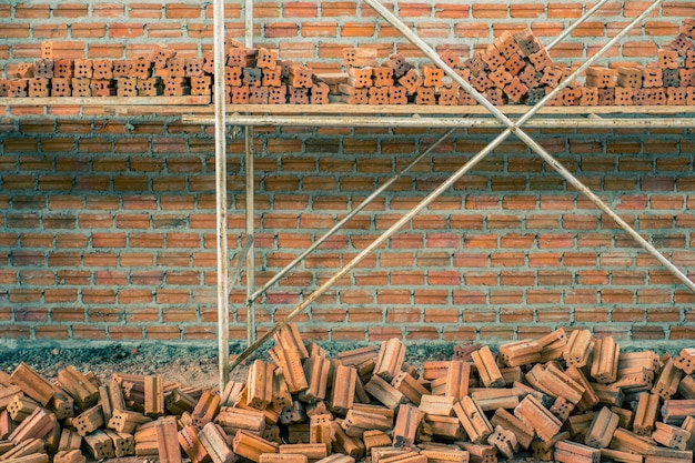 Premium Photo | New interior red brick wall with scaffolding under