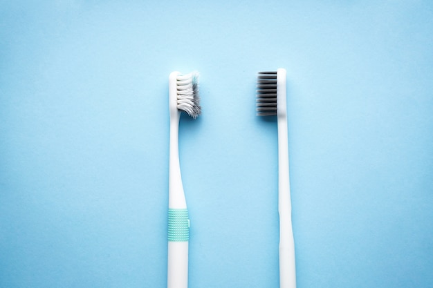 Premium Photo | New and old toothbrushes on blue