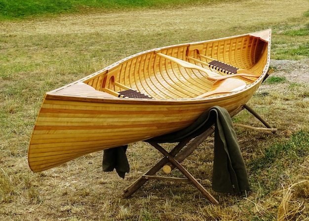Premium Photo | New, wooden boat, with paddles and benches.
