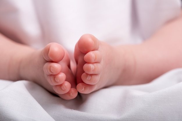 Premium Photo | Newborn baby feet on a white blanket, feet of baby boy,