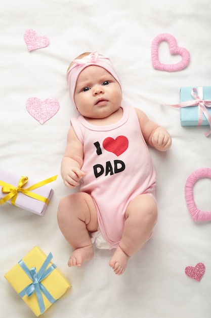 Premium Photo Newborn Baby Girl In T Shirt With Inscription I Love Dad Looking At Camera Valentine S Day Top View