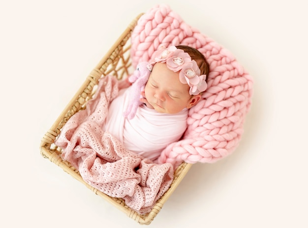 Premium Photo Newborn  baby  sleeping in the basket 