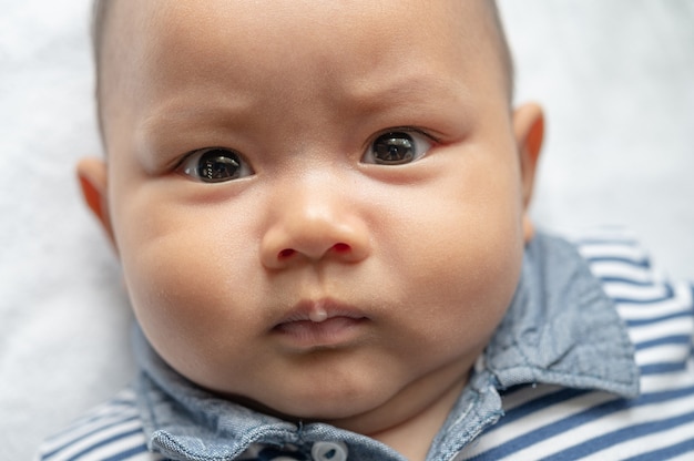 A newborn  baby  who opens his eyes and looks forward Free 