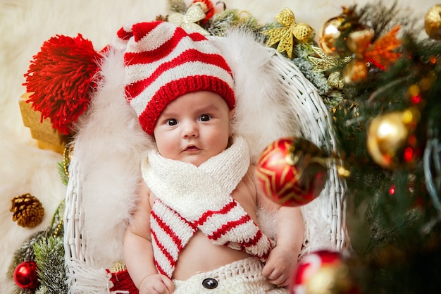 Premium Photo | A newborn under a christmas tree