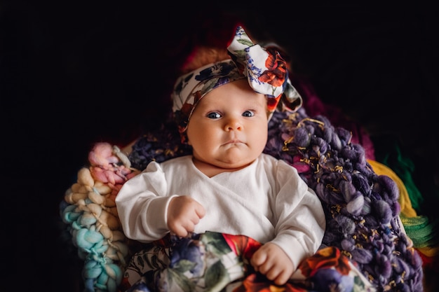 Premium Photo Newborn Looking To Camera Baby On Black Background Little Caucasian Baby Laying On Colourful Fabrics