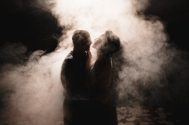 Premium Photo | Newlyweds dancing among smoke