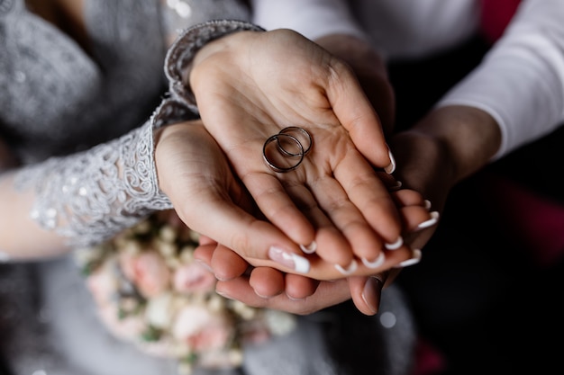 Free Photo Newlyweds Hold The Wedding Rings In Their Hands