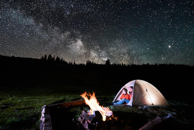 Premium Photo | Night camping in the mountains. romantic couple ...