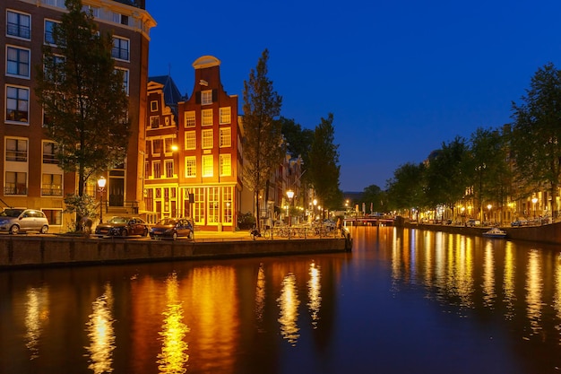 Premium Photo | Night city view of amsterdam canal, bridge and typical ...