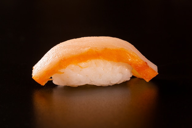 Premium Photo | Nigiri shiromi sushi with salmon fish on black background