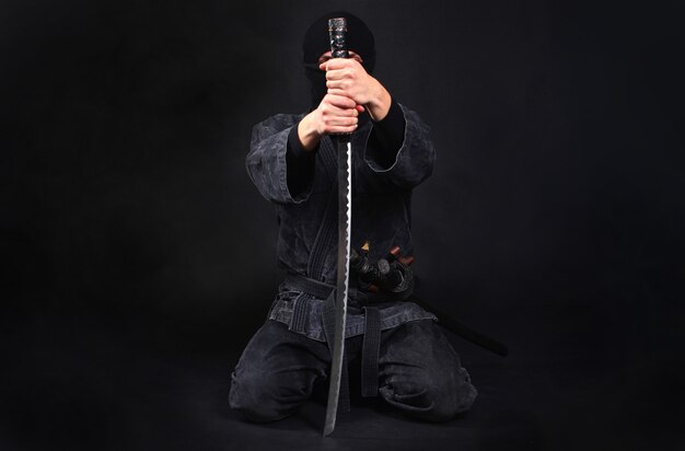 Premium Photo | Ninja Samurai Warrior Sits On His Knees And Covers His