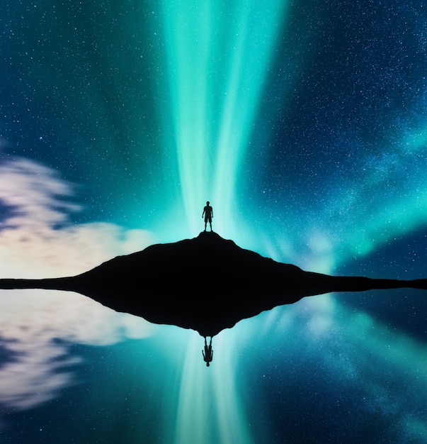 Premium Photo Northern Lights And Silhouette Of Standing Man In The Hill In Norway Aurora