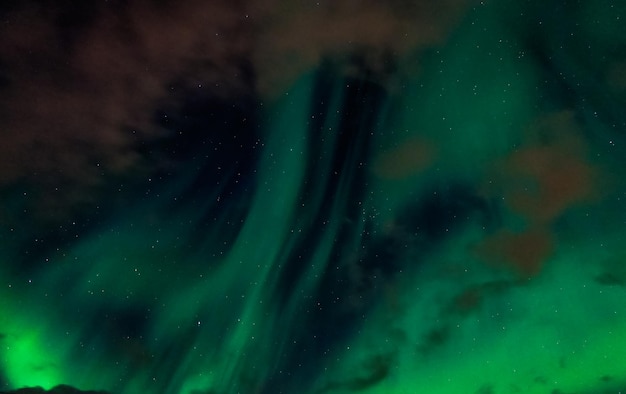 Premium Photo | Northern lights with clouds in the sky