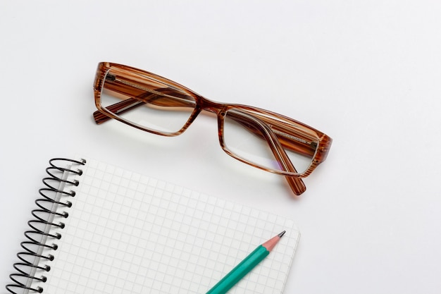 Premium Photo Notebook Pencil And Glasses On White Background Isolated