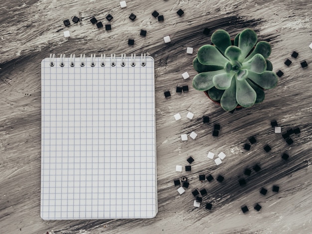 Notebook with flower on grey table. flat lay. Premium Photo
