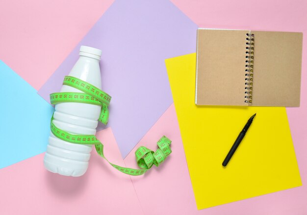 premium-photo-notepad-for-compiling-diet-plan-bottle-of-kefir