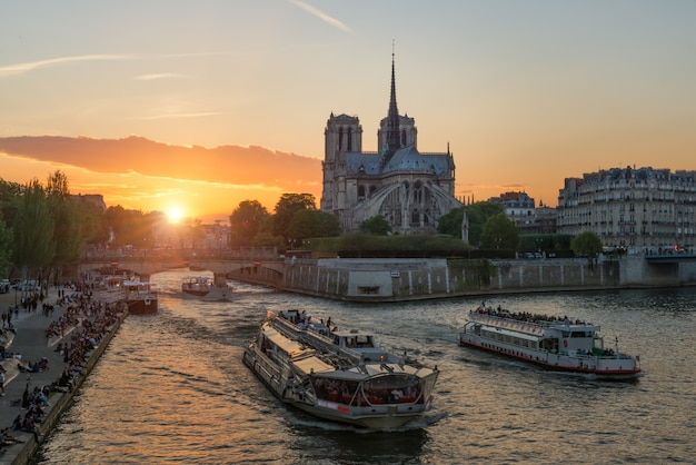 Premium Photo | Notre dame de paris cathedral with cruise ship in seine ...