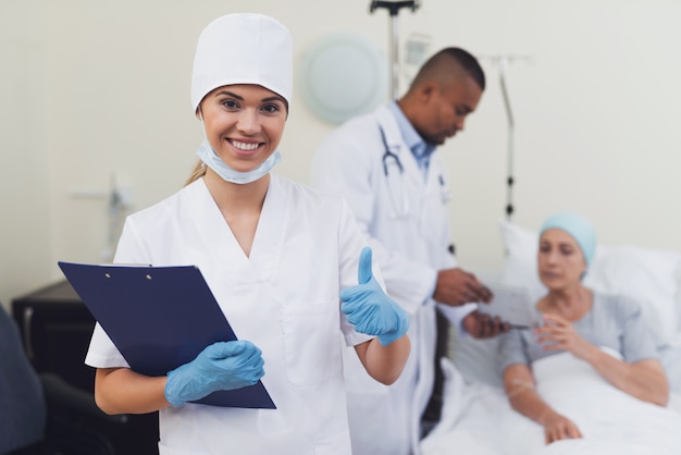 Premium Photo | A nurse is posing against the patient's background.