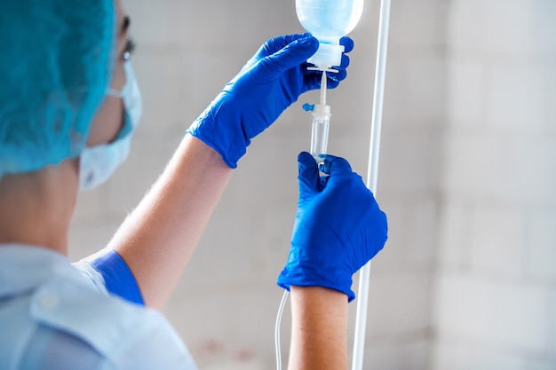 Premium Photo Nurse Preparing Drop Counter To A Patient For Procedure