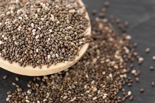 Nutritious chia seeds on a spoon, close up. Free Photo