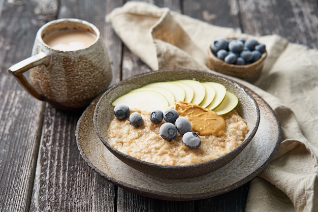 Premium Photo | Oatmeal, healthy porridge in large bowl with fruits ...