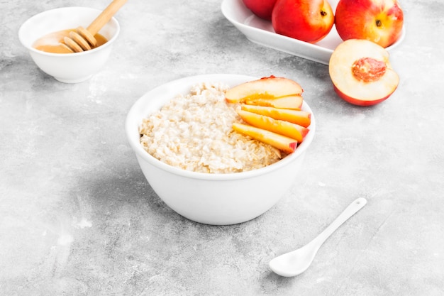 Premium Photo | Oatmeal with nectarine and honey