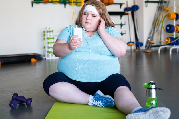 Premium Photo | Obese woman in fitness club