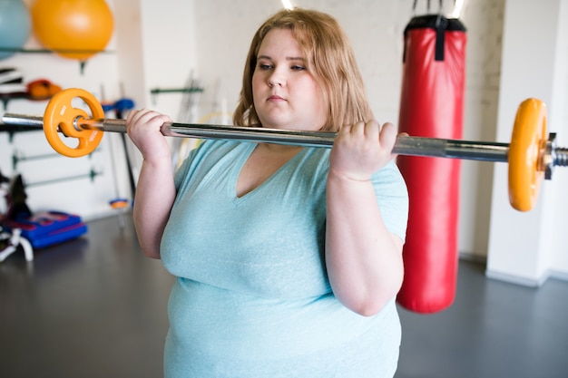 Premium Photo Obese Woman Holding Barbell