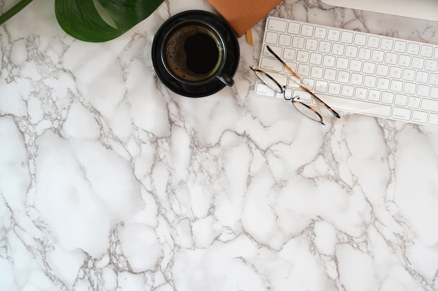 Office Desk With Office Supplies On Marble Desk Top Table Photo