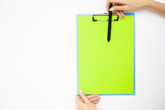 Premium Photo | Office hand holding a folder with a green color paper ...