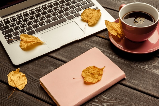 Office table with blank notebook and laptop Premium Photo