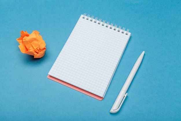 Office workspace with an empty notebook, crumpled paper Premium Photo