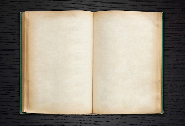 Old book open on dark wood background Photo Free Download