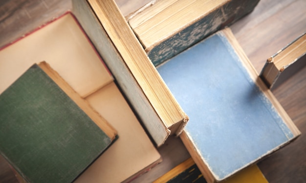 Premium Photo | Old books on wooden background.