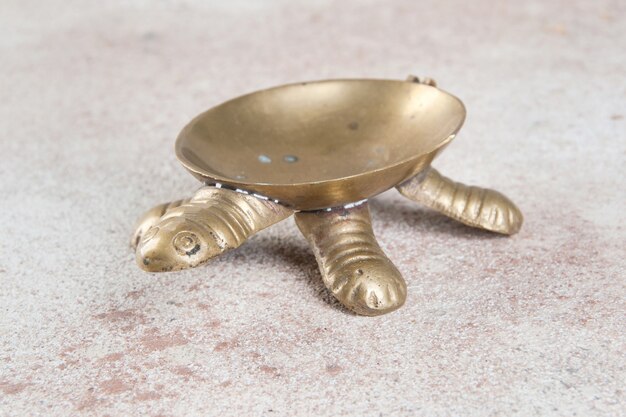 Premium Photo | Old brass turtle ashtray on concrete background. copy