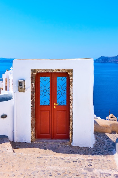 Premium Photo | Old door in santorini, greece. entrance to a building below