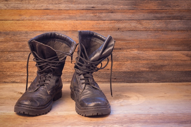 Premium Photo | Old leather black male shoes ankle boots on a wooden ...