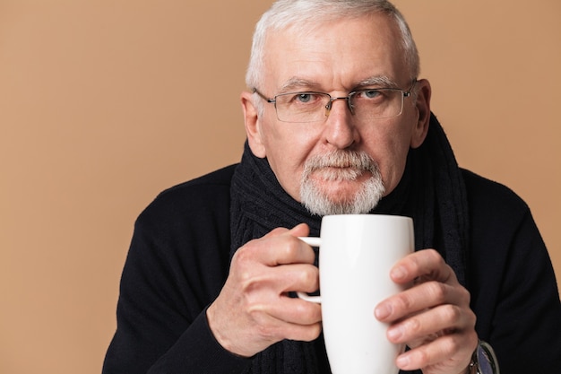 Premium Photo | Old man drinking tea portrait