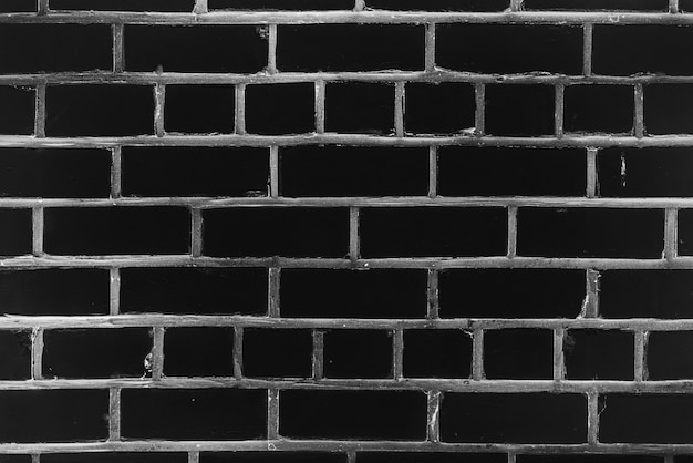 さまざまな色合いの黒いレンガで作られた古い現実的なレンガの壁 プレミアム写真