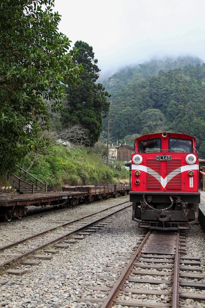 Premium Photo The Old Red Train In Alishan Line Downhill Come Back