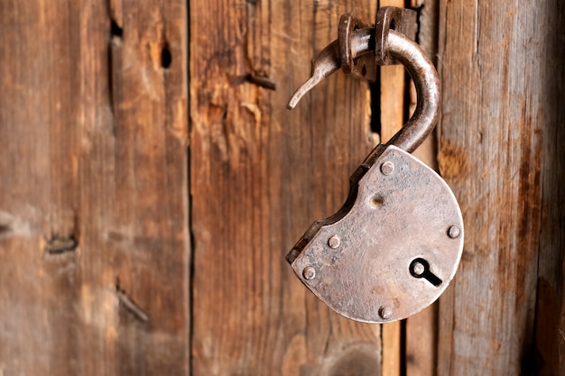 Premium Photo Old Rusty Padlock Close Up On A Wooden Door