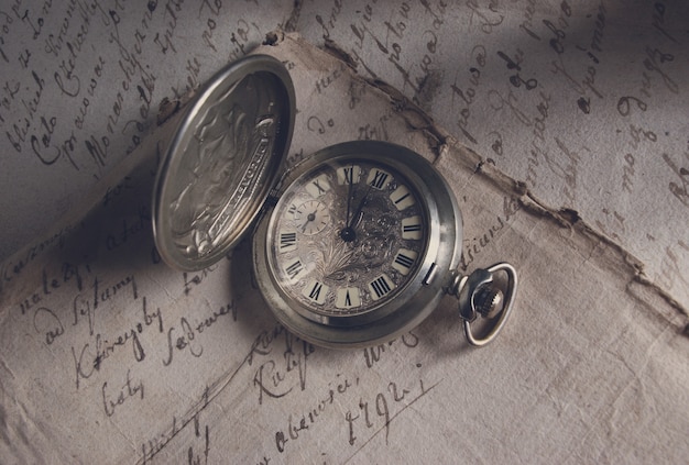 Premium Photo | Old-time watch,current of time,handwritten documents ...