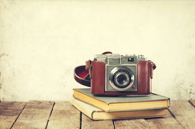 old vintage camera on old books on wooden background old vintage holiday concept_1220 1115