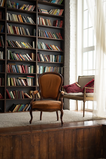 Premium Photo | Old wardrobe with lots of books and a chair next to it