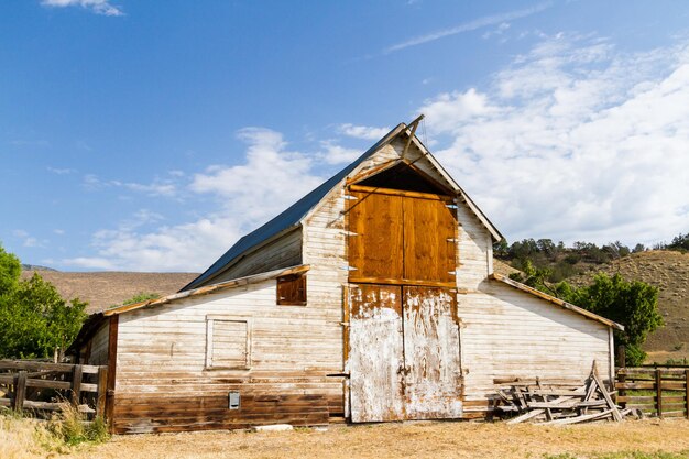 Premium Photo | Old white barn with farm yard.