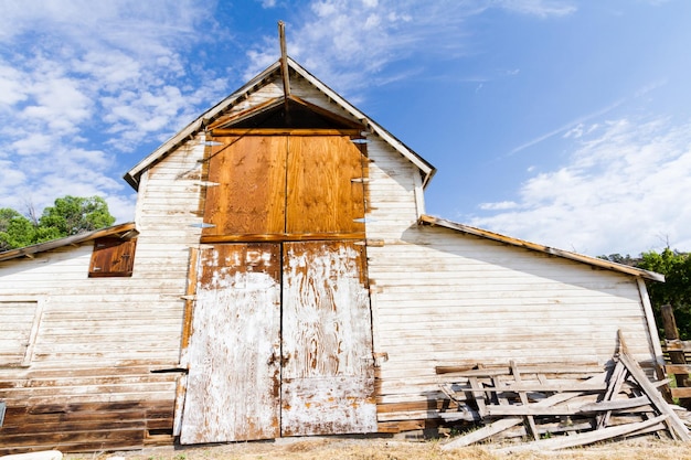 Premium Photo | Old white barn with farm yard.