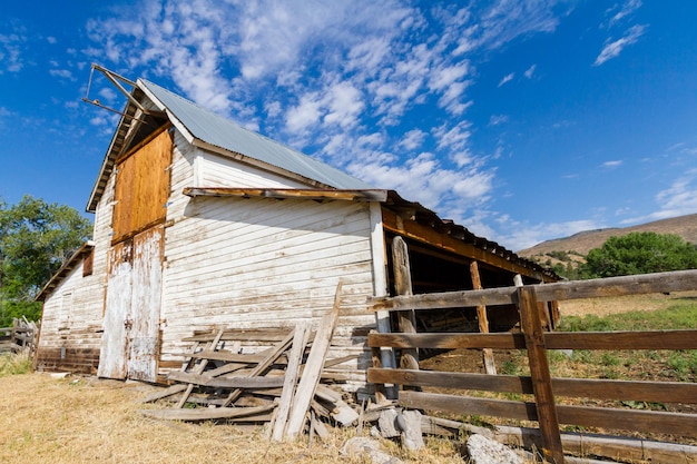 Premium Photo | Old white barn with farm yard.