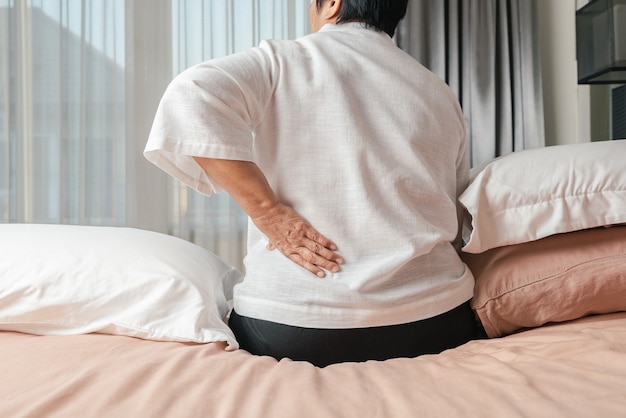 Premium Photo | Old woman back pain at home, health problem concept